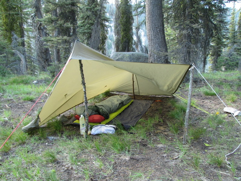 The SuperTarp is flexible in how you can set it up. By propping one end up with a stick and a little cordage, I'm able to get great ventilation and take an afternoon nap without getting to hot. I am only using a total of 7 stakes in that set up. One on each of the four corners of the tarp, 1 on each side guy out, and 1 on the front guy out.